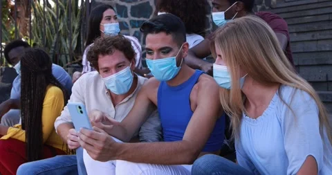 Multiracial young people having fun using mobile phone in the city Stock Footage 158223774