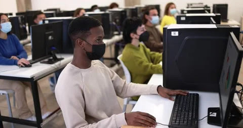 Multiracial young students using computers inside class room Stock Footage 168622337