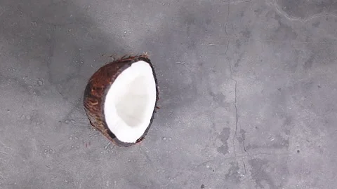 Multishot slow motion half coconut falling Stock Footage 147096496