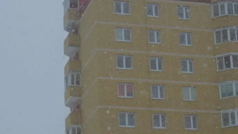 Multistorey panel home, new building on background snow falls. Stock Footage 236316238