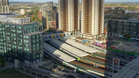 Multistorey tower blocks, with a train pulling into a London train station. Video stock 254338291