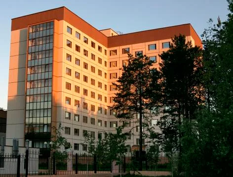 Multistoried dwelling building on a background sky during sunset Stock Photos