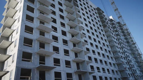 Multistory building and tower crane at construction site 動画素材 330991308
