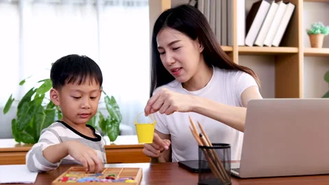 Multitasking Asian mother playing with kid while working at home, lifestyle.. Stock Footage 244461920