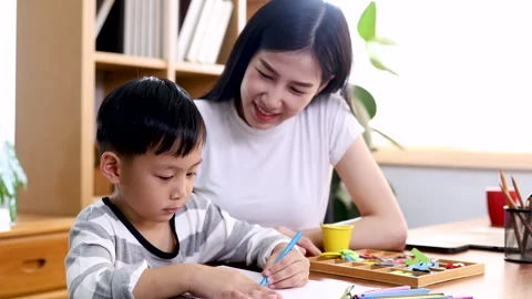 Multitasking Asian mother playing with kid while working at home, lifestyle.. Stock Footage 244983822
