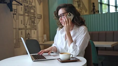 Multitasking concept. Woman using laptop, drink coffee, talking smartphone Stock Footage 302155814