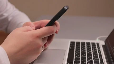 Multitasking at desk. Professional reviewing multiple devices. Focus on work Stock Footage 347880187