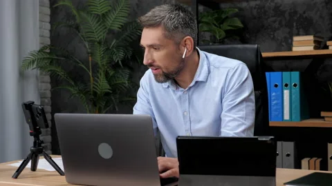 Multitasking man stock trader broker using laptop, tablet and smartphone Stock Footage 168727324