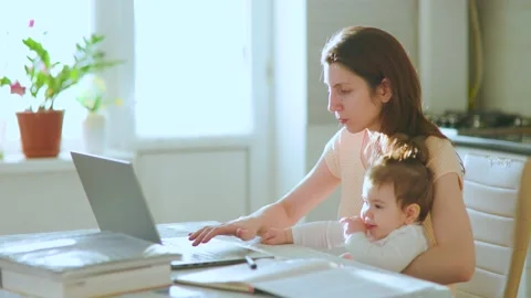 A multitasking mom With Little Child working remote is stressed out, Stock Footage 172222503