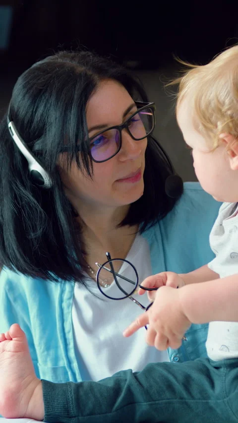 Multitasking mom With Little Child working remote is stressed out, using laptop. Stock Footage 329798602