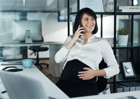 Multitasking is my super power. an attractive pregnant businesswoman sitting Stock Photos