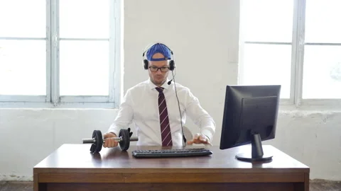 Multitasking at office concept: caucasian handsome worker with dumbbell Stock Footage 143262887