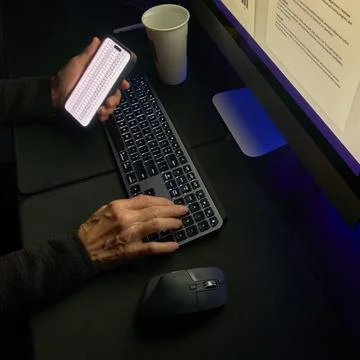 Multitasking with Smartphone and Computer in Office Setting Stock Photos