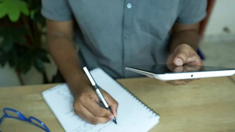 Multitasking with Smartphone and Notepad, Person using a smartphone and tak.. Stock Footage 317737214