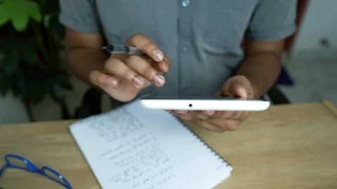 Multitasking with Smartphone and Notepad, Person using a smartphone and tak.. Stock Footage 317737223