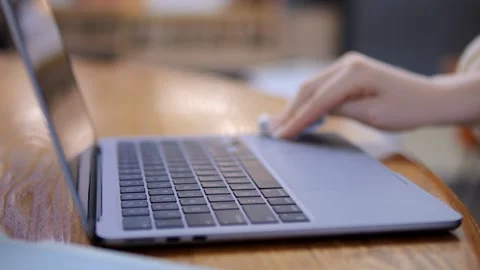 Multitasking woman using phone and laptop at cafe Stock Footage 341479296
