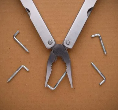 Multitool on cardboard. A tool for a variety of cases Foto stock