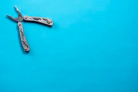 Multitool in the corner of the frame on a blue background Foto stock
