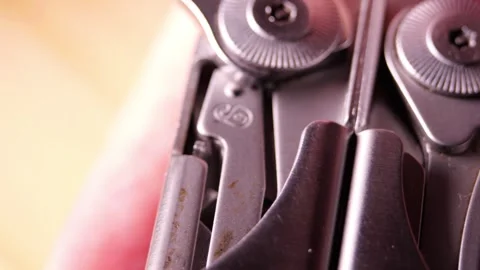 Multitool knife blade lock engaging prevent folding close up engineering Stock Footage 320897444