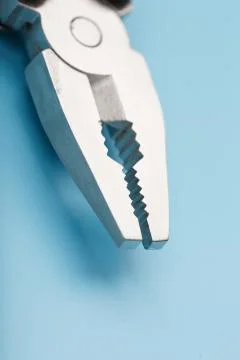 The multitool multi-function tool hovers on a blue background. The concept of Stock Photos