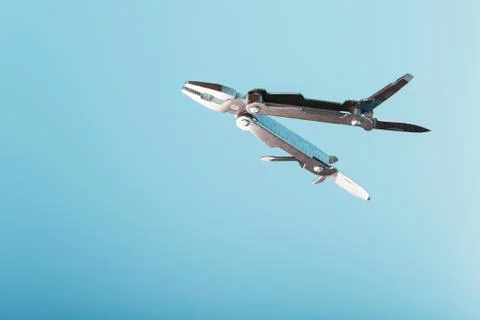 The multitool multi-function tool hovers on a blue background. The concept of Stock Photos