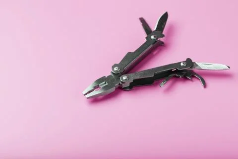 Multitool is a multi-functional tool on a pink background. The concept of an  스톡 사진