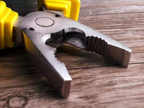 Multitool pliers on wooden background Stock Photos