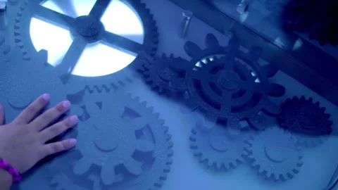 A multitude of black gears rotate under the glass Stock Footage 323919762