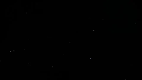 A multitude of dust specks drift through the air,4k Vidéo 306419370