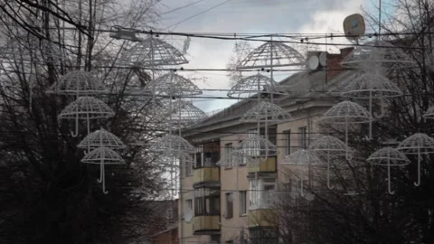 A multitude of white umbrellas suspended seen from below Stock Footage 120007593