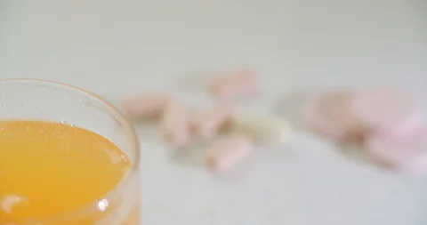 Multivitamin tablets in a glass of water Stock Footage 128409643