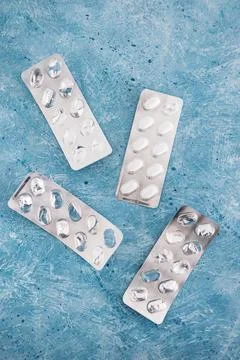 Multivitamins pills or medicine tablets into blister packs next to other em.. Stock Photos