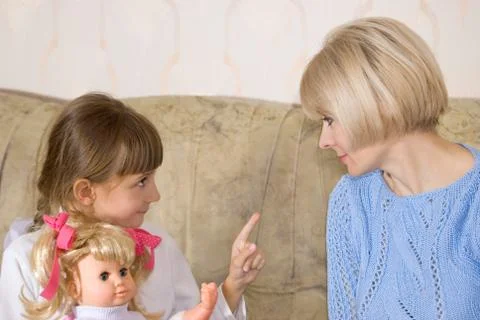Mum and daughter with a doll Stock Photos