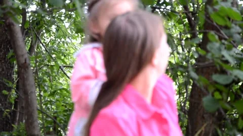 Mum and daughter sitting outside by the lake Stock Footage 131237201