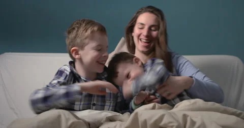 Mum and her two sons having fun in bed Stock Footage 61265219