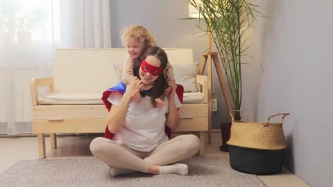 Mum and kid having fun smiling and hugging woman sitting with crossed legs Видео 263618982