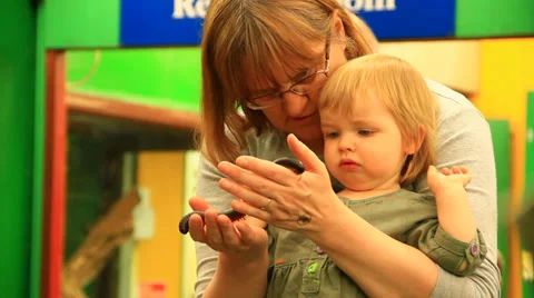 Mum and son Looking at centipede Stock Footage 38718462