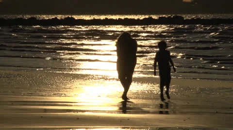 Mum and son searching seashells silhouetted Stock Footage 26947258