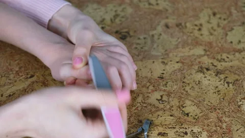 Mum is cutting hangnail to her son by Clippers on wood backgound and file him Vídeos de archivo 85757845
