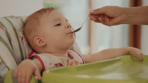 Mum Feeds the Child with a Spoon Stock Footage 84758382