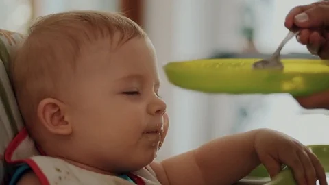 Mum Feeds the Child with a Spoon Stock Footage 84758956