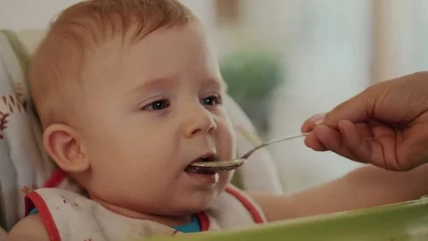 Mum Feeds the Child with a Spoon Stock Footage 84759367