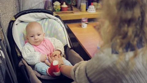 Mum feeds with a spoon her cute newborn baby puree of zucchini closeup Stock Footage 99831762