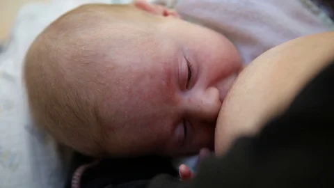 Mum nurses her two month old daughter, with love 스톡 동영상 83176918