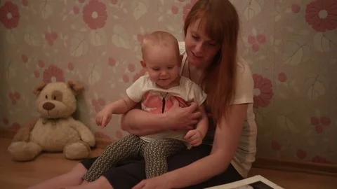 Mum with a small daughter leafed through a photo album 스톡 동영상 70711057