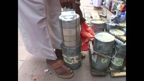 MUMBAI - 1999 - A dabbawala opens compartments of a food canister in Mumbai, Stock Footage 284462188