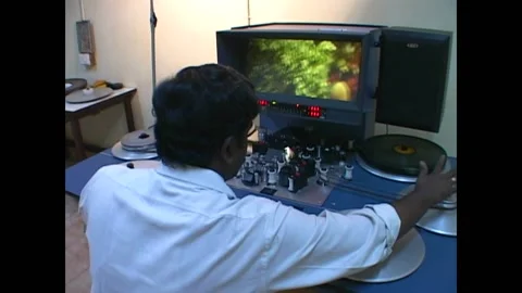 MUMBAI - 1999 - Low angle view of cameramen using a dolly on a Bollywood movie. Stock Footage 277254575