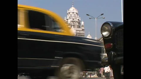 MUMBAI - 1999 - Low angle view of traffic driving past the Western Railway Stock Footage 284462818
