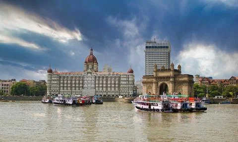 Mumbai, India: Wide angle shot of Gateway of India and Taj hotel against sea  Stock Photos