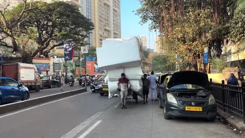 Mumbai Laborers Pulling a Massive Overloaded Handcart Through City Traffic Stock Footage 327080437